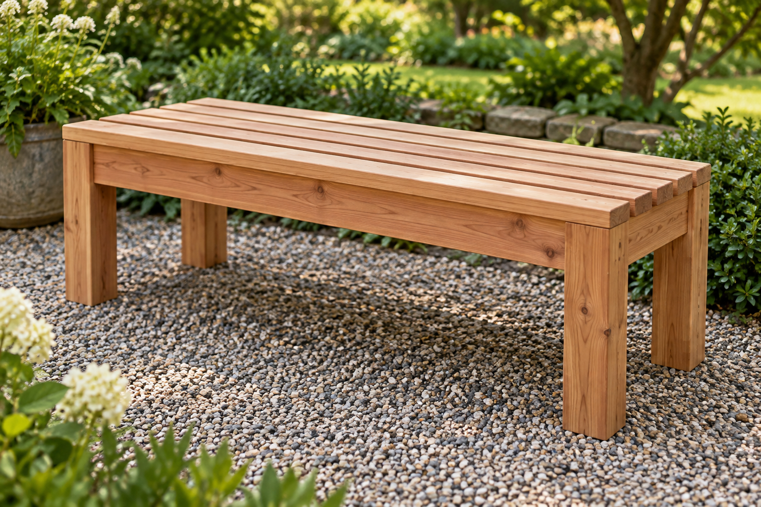 Slatted cedar garden bench on a gravel patio